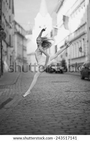 Young ballet dancer jumping in the street, monochrome