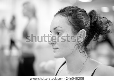 Bikram yoga class, young woman face with tired expression