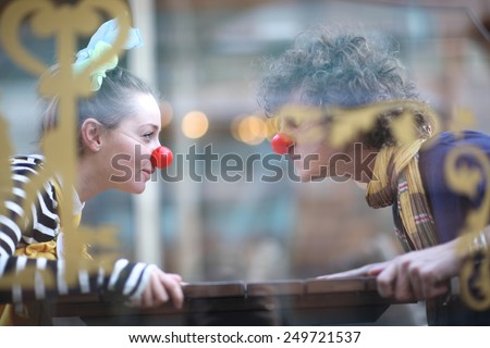 Clowns facing each other; street theater concept
