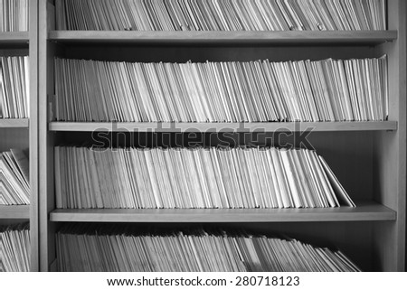 Closeup of shelves full of folders, monochrome