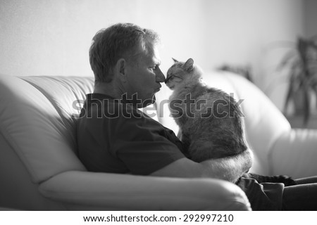 Profile of an elderly man and a cat arguing