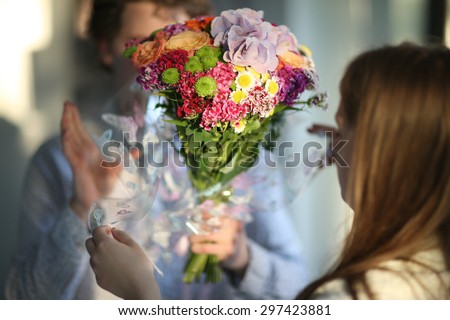 Beautiful bouquet in hands of a man for a woman