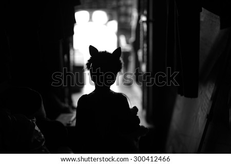 Backstage theater; silhouette of a child actor in cat ears handband