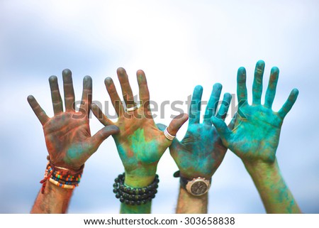 Raised colorful hands at holi festival