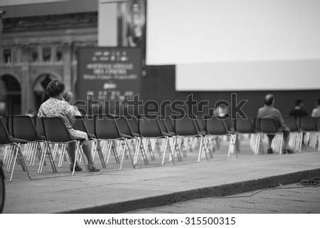 Few people at open-air cinema hall waiting for a movie