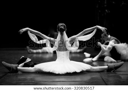 Gorgeous ballerina repeating movements backstage