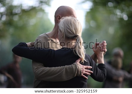 Partner dance, a man leading a woman in the dance