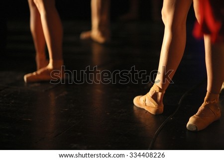Low section of graceful ballet dancers performing on the stage
