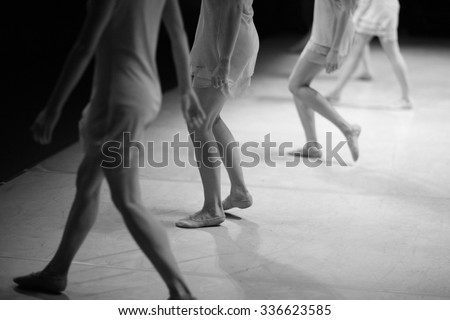 Modern ballet dance performance, low section of dancers on stage