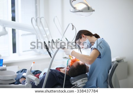 Dentist working without assistant