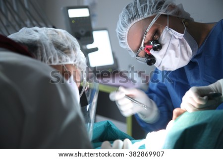 modern dental surgery, face of a female doctor working on a patient