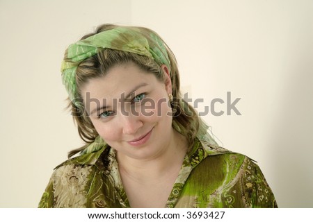 portrait of woman wearing green blouse and headband