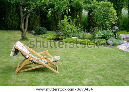 wooden garden chair in beautiful green garden