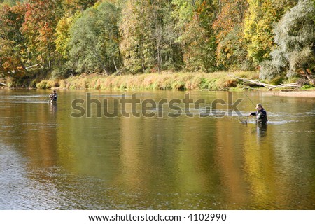 two fishermen in river fishing