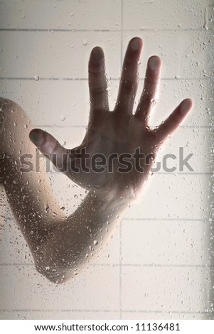 hand on glass with jets of water