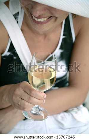 Smiling woman holding a glass of white wine