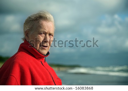 Old woman portrait on the Baltic sea background