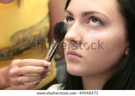 work of makeup artista with face of beautiful girl