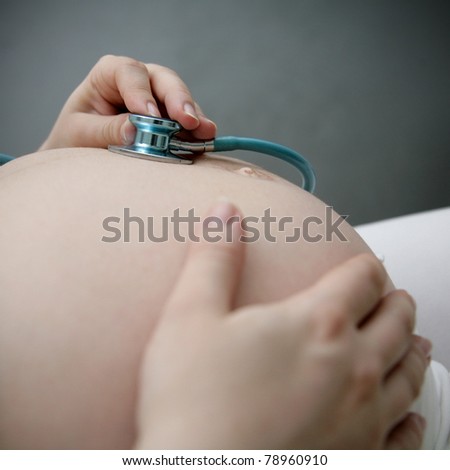 pregnant woman listening to baby\'s heartbeat