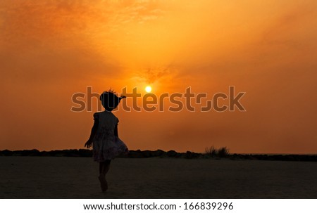 Girl running towards the sun