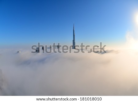 DUBAI, UAE - FEB 22: Burj khalifa, the highest building in the world, Downtown is covered by early morning fog on February 22, 2014 in Dubai, UAE