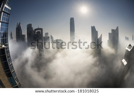 DUBAI, UAE - MAR 6: Burj khalifa, the highest building in the world, Downtown is covered by early morning fog on March,6 2014 in Dubai, UAE