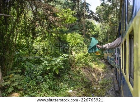 NILGIRI, TAMILNADU, INDIA - SEP 25: Nilgiri Mountain train to Ooty on the move on September 25, 2014 in Nilgiri mountains, Tamilnadu, India.