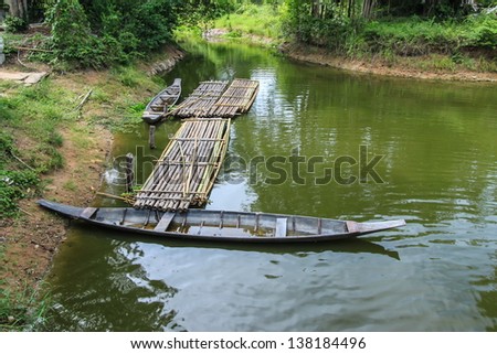 wooden boat and bamboo raft in the river