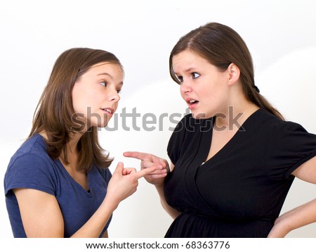 Sisters pointing their fingers at each other in an accusing fashions as they argue with each other