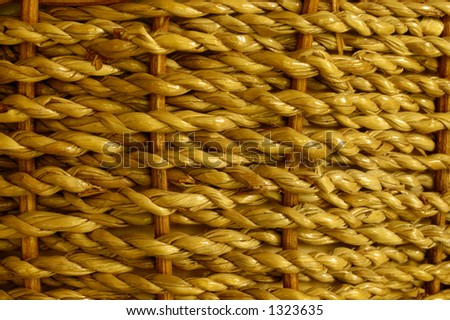 Stock macro photo of the texture of a basket woven from grass cord. The basket is wet and shiny. Useful for layer masks or as a patterned background. Focus falls off at RH edge to give depth.