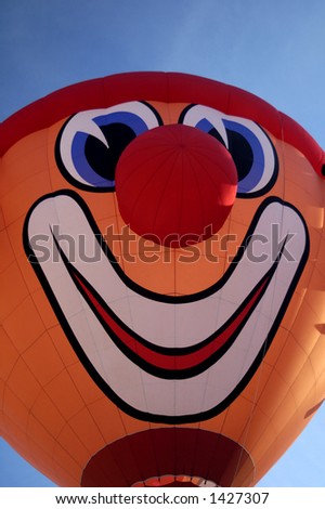 Smile please! A balloon taking off from the Chateau d\'Oex ballon festival in Switzerland