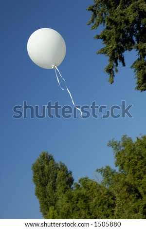 A child\'s balloon floats away into a clear blue summer sky.