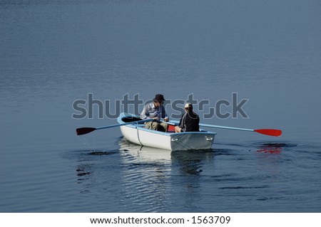 Father and son set off in their rowing boat, out on to the lake one calm sumer\'s morning
