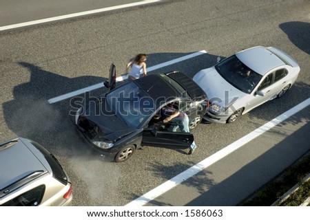 A small shunt on the freeway (motorway, autoroute, autobahn) a few seconds after it happened. Smoke is coming from under the bonnet of the black car. Motion blur on the passenger fleeing in panic.