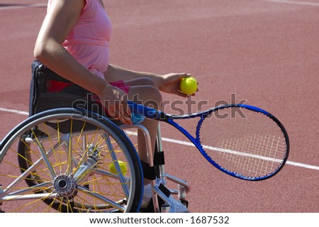 Detail of a wheelchair tennis player about to serve during a tennis championship match. Space for text on the plain area of the court behind her.