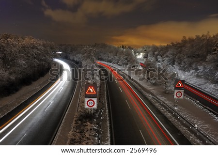 A Swiss freeway (autoroute) at night, after a fall of snow.