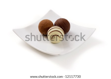 chocolate sweets Stock-photo-three-chocolate-truffle-in-a-white-plate-isolated-over-a-white-background-12117730