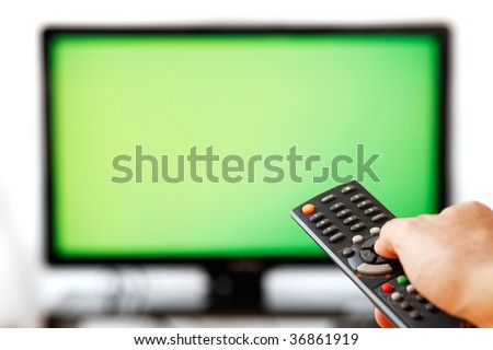 Out of focus TV LCD set and remote control in man\'s hand isolated over a white background. Blank screen.
