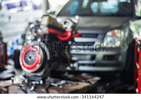 Blurred background : Car technician repairing the car in garage.
