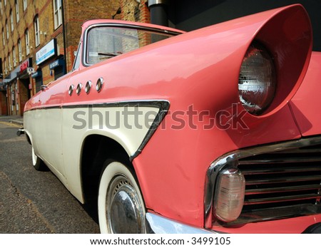 stock-photo-stylish-old-pink-car-on-an-old-street-3499105.jpg