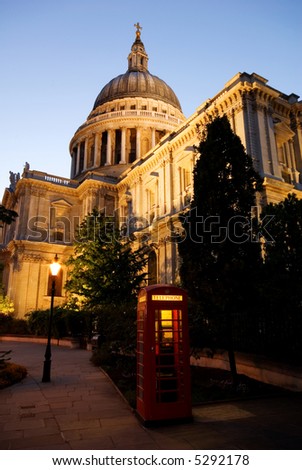 Red London Telephone box in front of St. Paul\'s cathedral in the evening