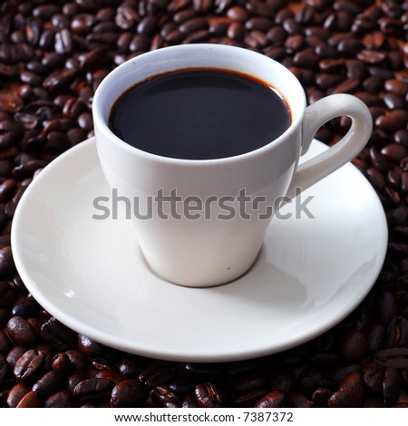 A delicious cup of espresso with coffee bean background