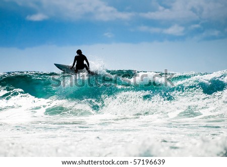 Surfing in nice  weather with great waves and blue skyline.
