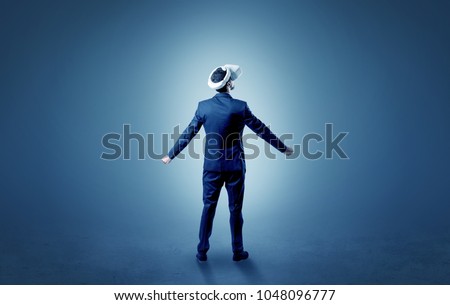 Businessman wearing vr glasses in an empty room with no wallpaper