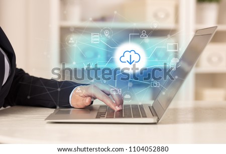 Business woman in homey environment using laptop with  online storage and cloud technology concept