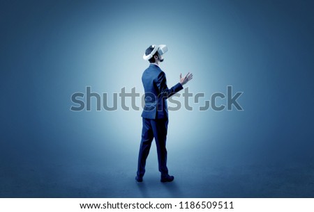 Businessman wearing vj glasse in an empty room with no wallpaper