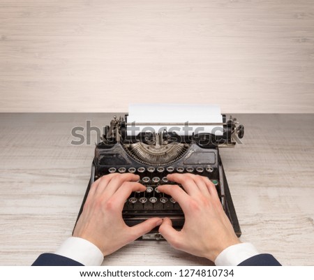 First person perspective elegant hand writing on an oldschool typewriter with copyspace