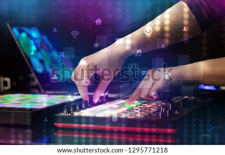 Hand mixing music on dj controller with social media concept icons