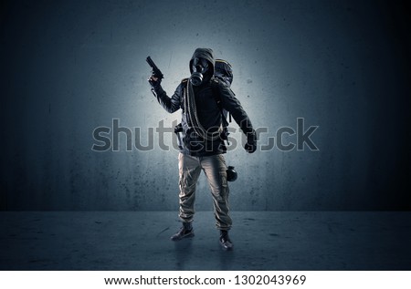 Bad agent in a dark room with arms on his hand and gas mask
