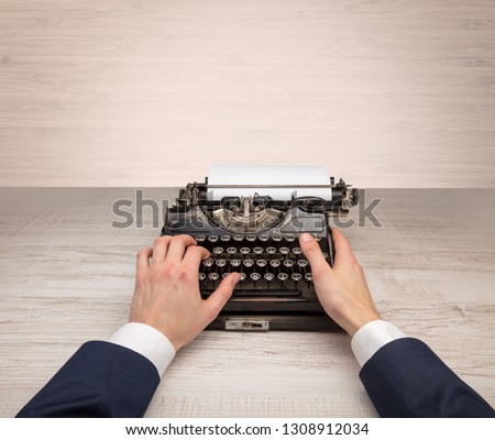 First person perspective elegant hand writing on an oldschool typewriter with copyspace